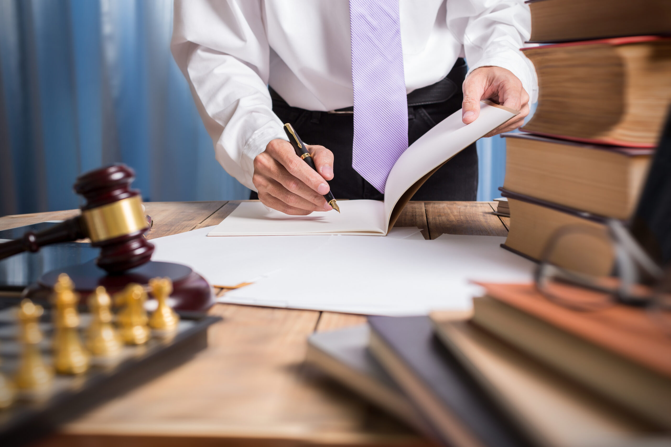 Young,Lawyer,Business,Man,Working,With,Paperwork,On,His,Desk